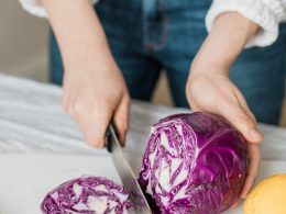 woman slicing purple vegetable