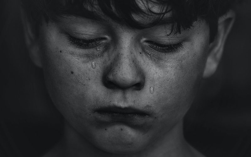 a boy crying tears for his loss