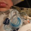 clear pacifier on white textile