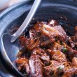 meat with sauce in black bowl